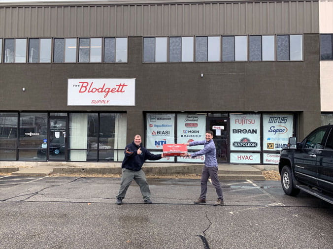 Blodgett Supply building exterior with two teammmates staning out front